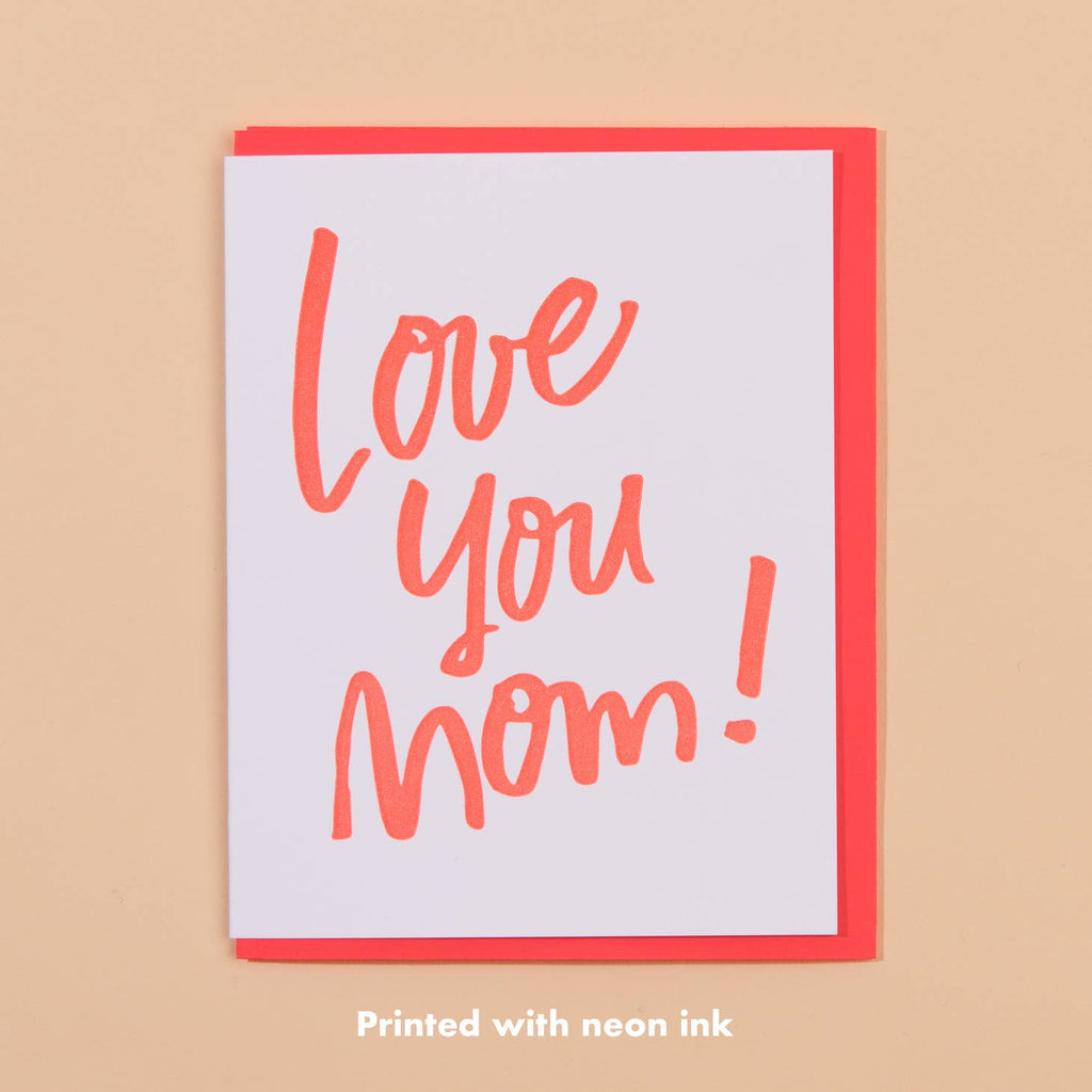 White card with neon red text that says “Love you Mom!”. Neon red envelope included.       