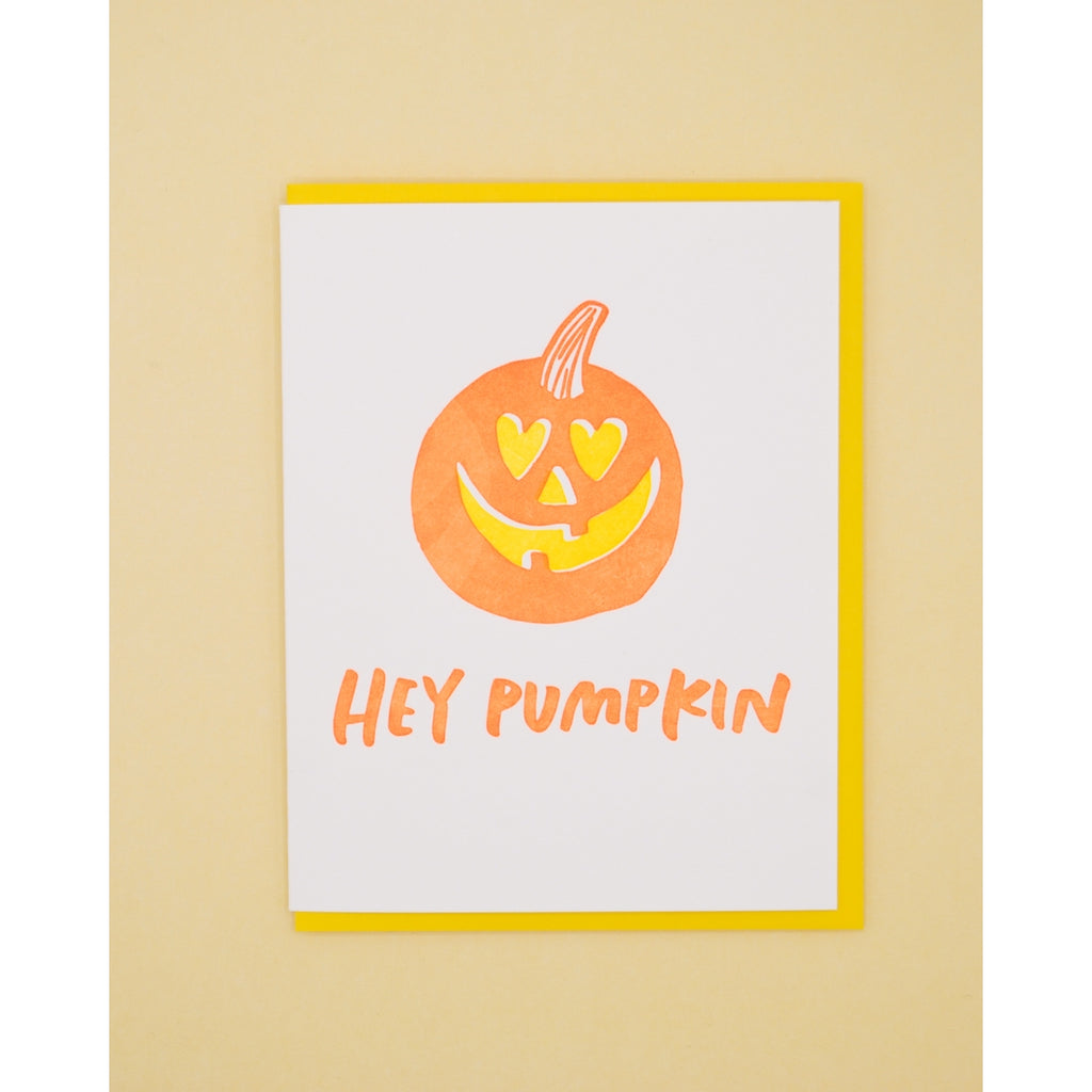 White card with orange text saying, "Hey Pumpkin". Image of a pumpkin jack o lantern with heart shaped eyes. A yellow envelope is included.