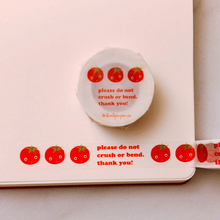 Decorative tape with clear background and red text saying, “Please Do Not Crush or Bend. Thank You!” Images of red tomatoes. 