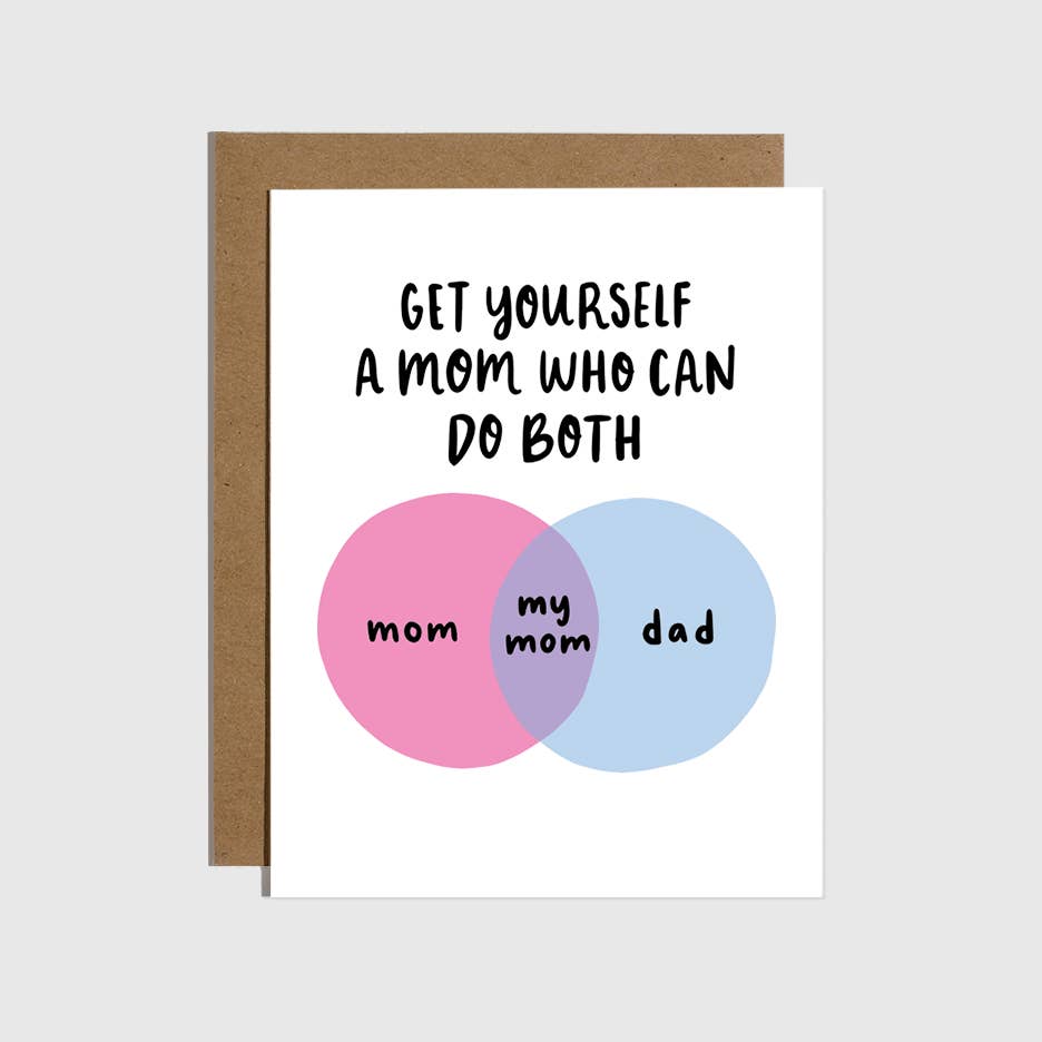 White card with two intersecting circles, one pink  with black text says “Mom” and one blue with black text says “Dad”. At the intersection it is light purple with black text says “my mom”. Black text says “Get yourself a mom who can do both”. Brown envelope is included.