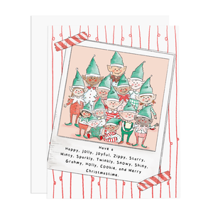 White card with black text saying, “Have A Happy, Jolly, Joyful, Zippy, Starry, Minty, Sparkly, Twinkly, Snowy, Shiny, Grahmy, Holly, Cookie and Merry Christmastime”. Images of red vertical stripes going down card with a family photo of a family of elves in center of card. A white envelope is included.