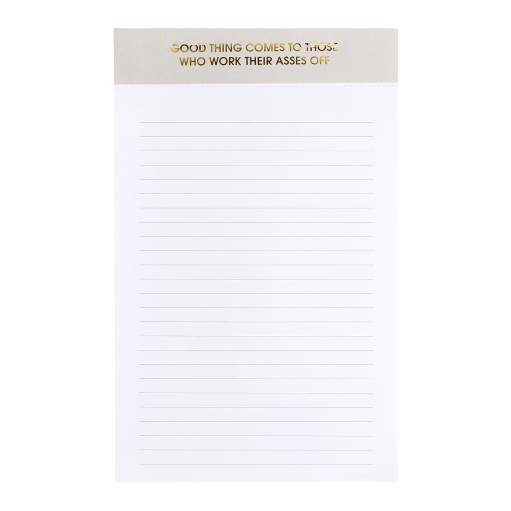 Image of a notepad with white lined paper a grey binding with gold foil text says, “Good things come to those who work their asses off”. 