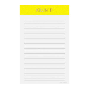 Image of a notepad with white lined paper and yellow binding with gold foil text says, “Killin’ It”. 