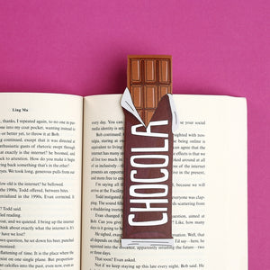 Image of opened book with bookmark in the shape of a chocolate candy bar in brown and white.