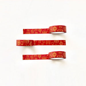 Decorative tape with red background and images of Chinese Lunar New Year symbols in gold foil.