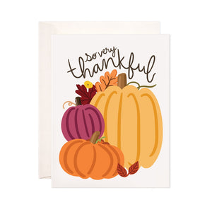 Ivory card with brown text saying, "So Very Thankful". Images of pumpkins and fall leaves. An ivory envelope is included.