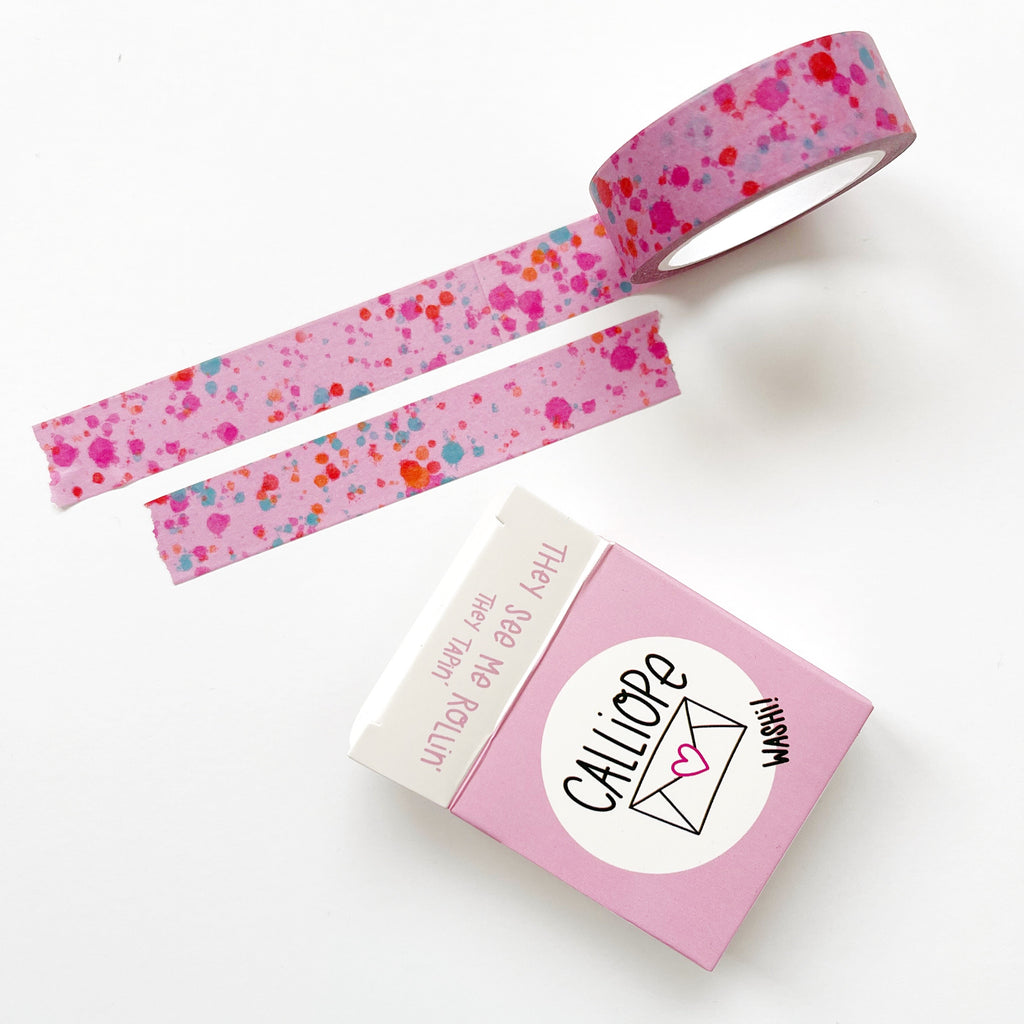 Image of Washi tape with pink background and spatters of blue, orange, pink and gold foil. 