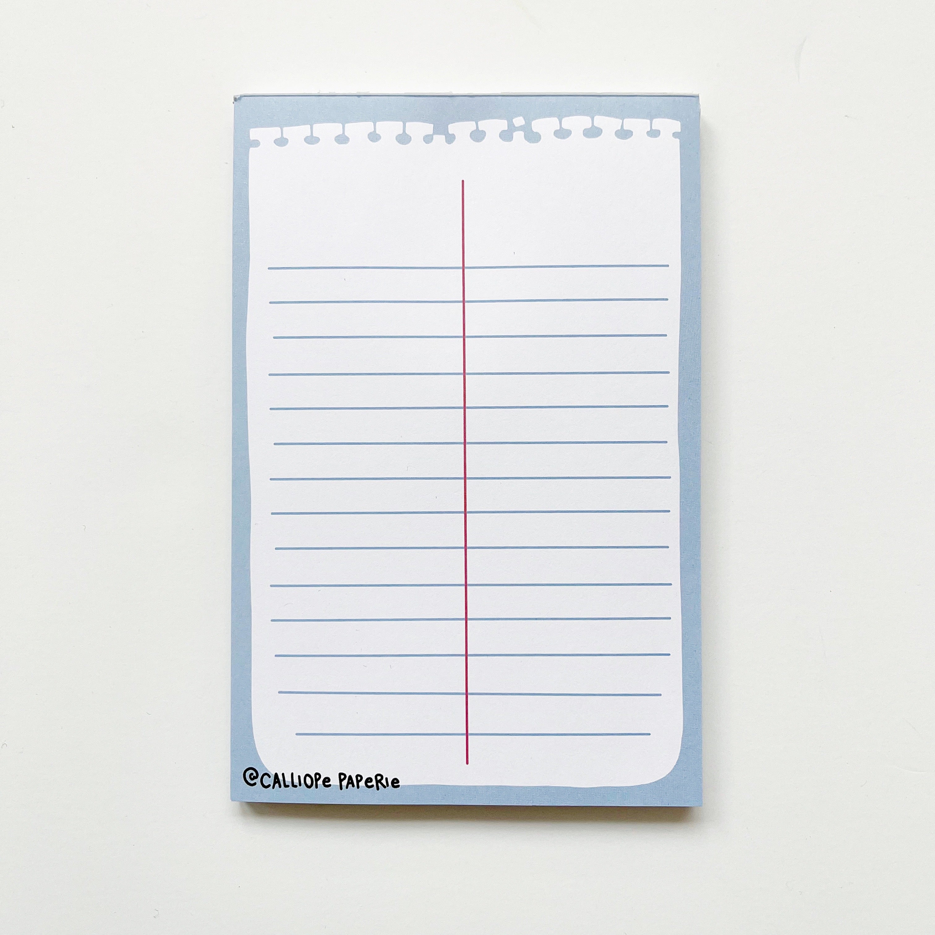 Image of notepad with image of white piece of memo notepad paper with blue lines and a red vertical line down the middle on a blue background. 