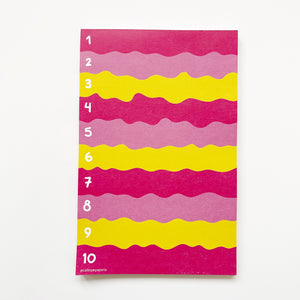 Image of notepad with wavy blocks of colors in hot pink, pink and yellow with white text says, "1 - 10"  on left side of notepad. 