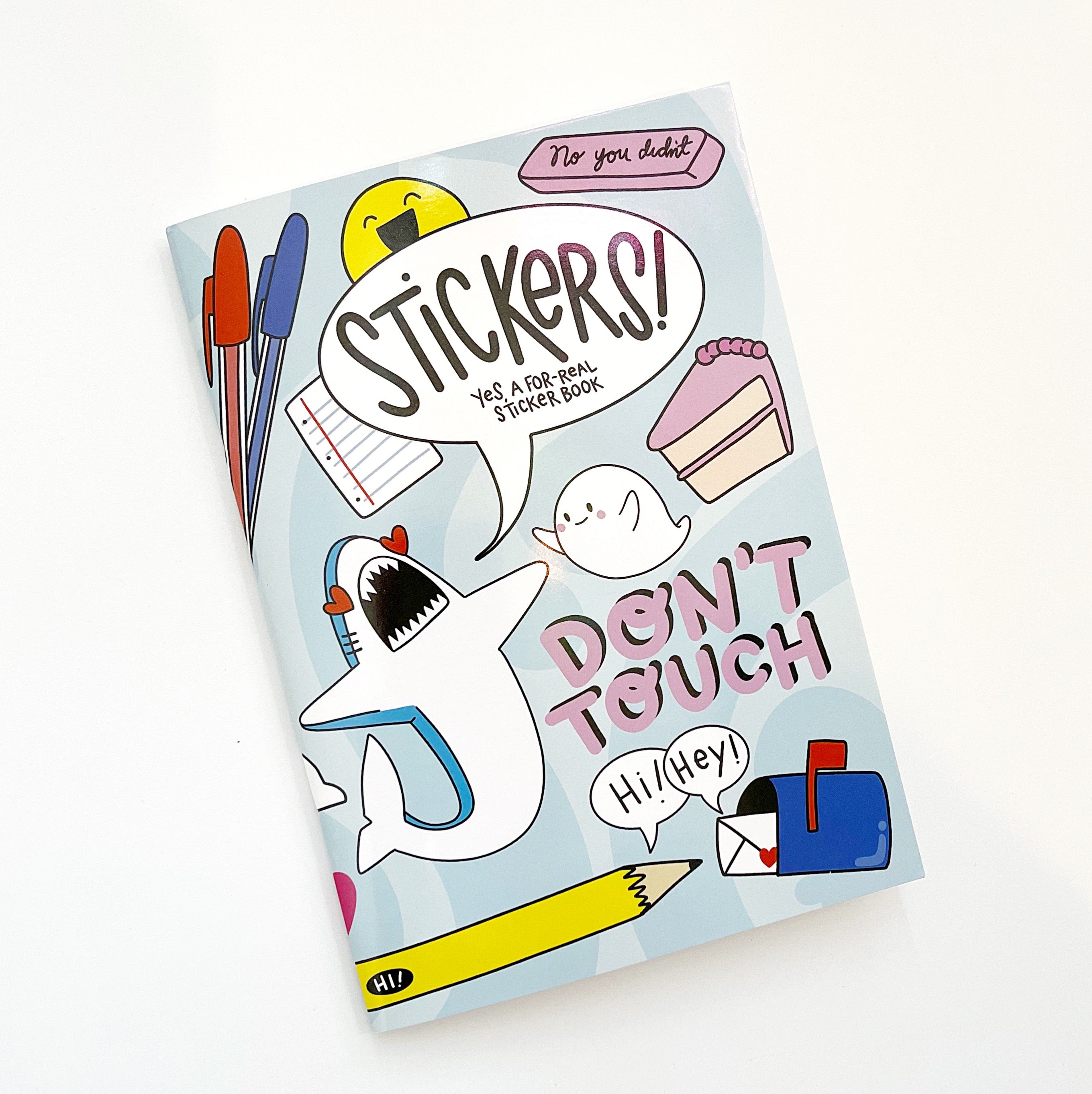 Image of book cover with light blue background and images of pens, shark, cake, ghost, mailbox and pencil with black text says, "Stickers yes a for-real sticker book" Pink text says, "Don't touch". 