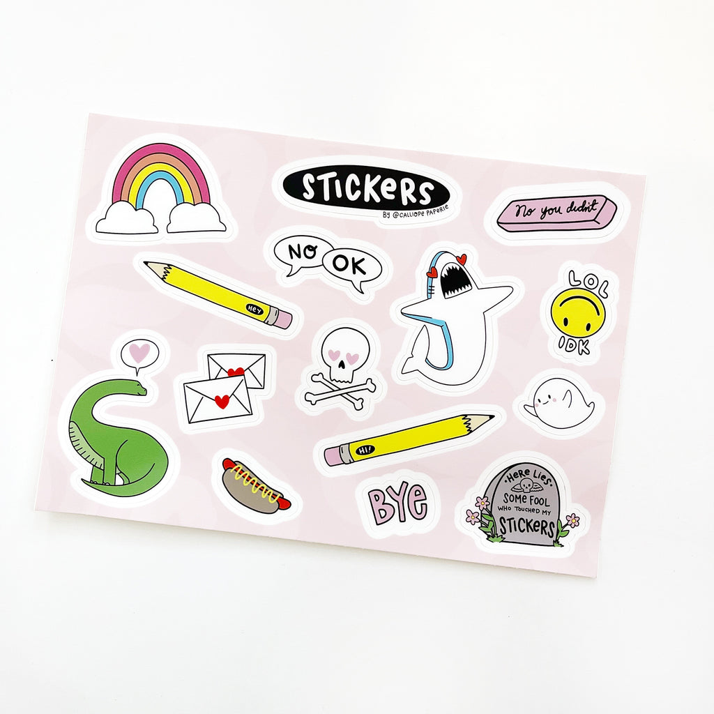 Pink background with sticker images of green dinosaur, yellow pencil, rainbow with clouds, shark, ghost, and pink eraser. 