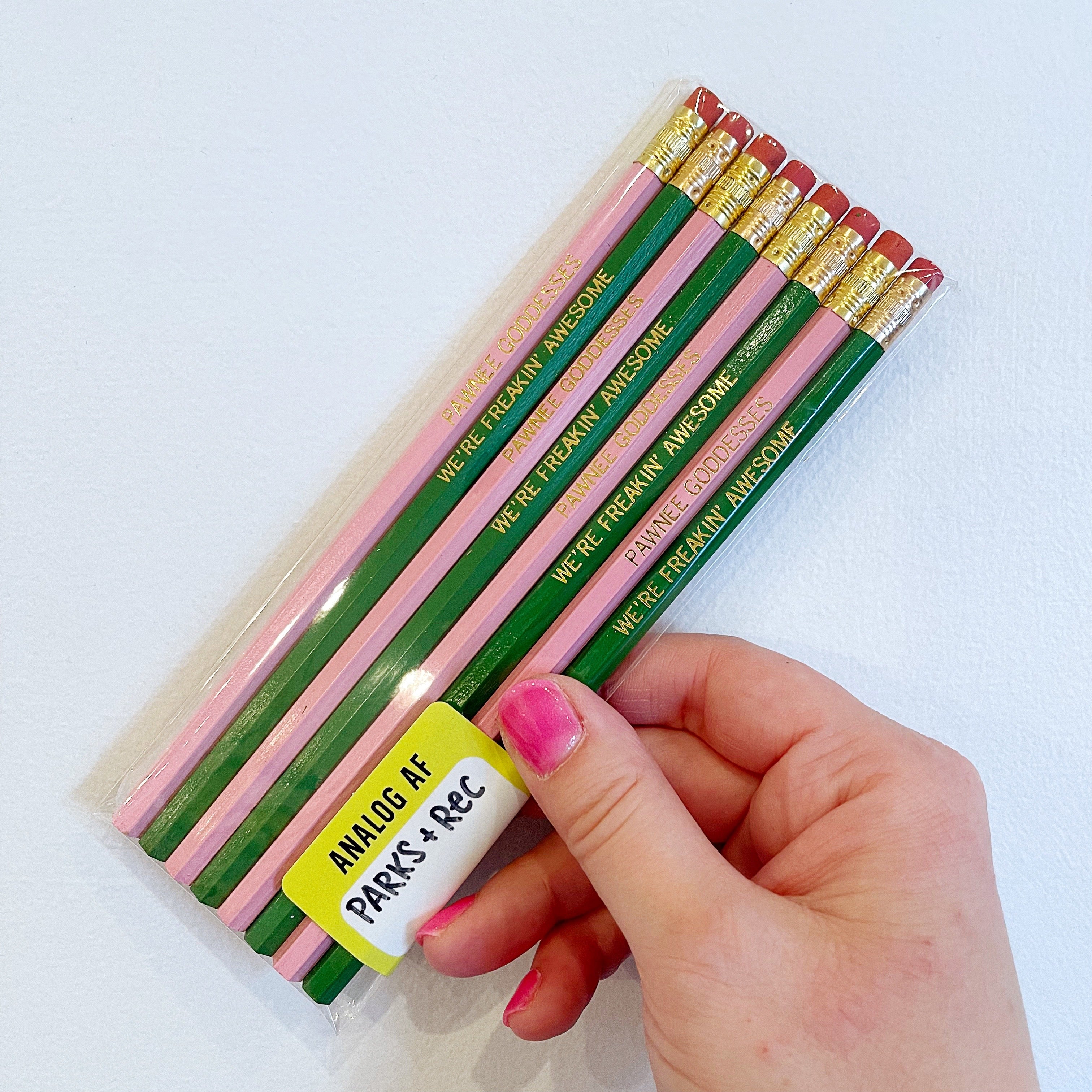Image of pencils in pink and green with gold text says, 'Pawnee Goddesses" and "We're freakin awesome". 