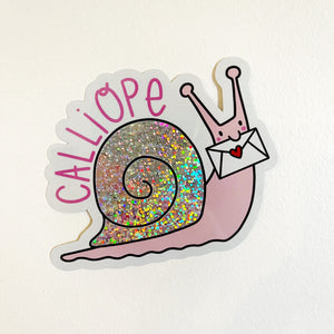Image of snail with pink body and holographic shell holding an envelope in its mouth. Bright pink text says, "Calliope". 