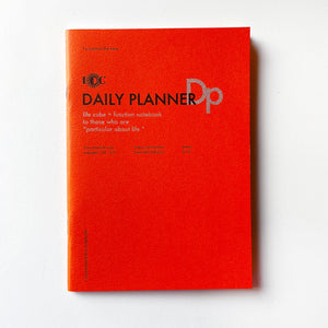 Red background with black text says, “Daily Planner” and grey text says, “life cube + function notebook, to those who are ‘particular about life’. “