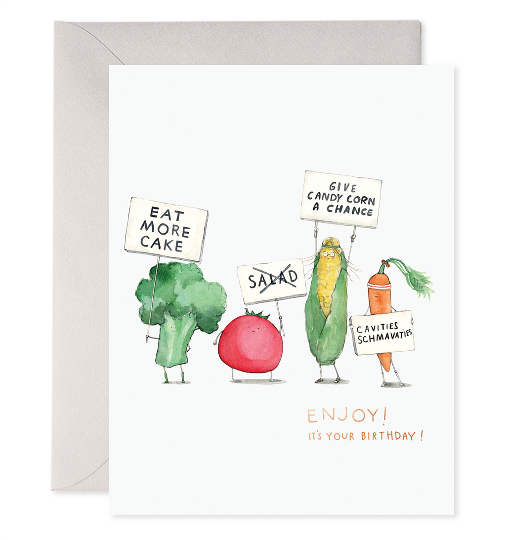 White card with orange and black text saying, “Enjoy Your Birthday!”. Images of vegetables holding on strike signs. A gray envelope is included.