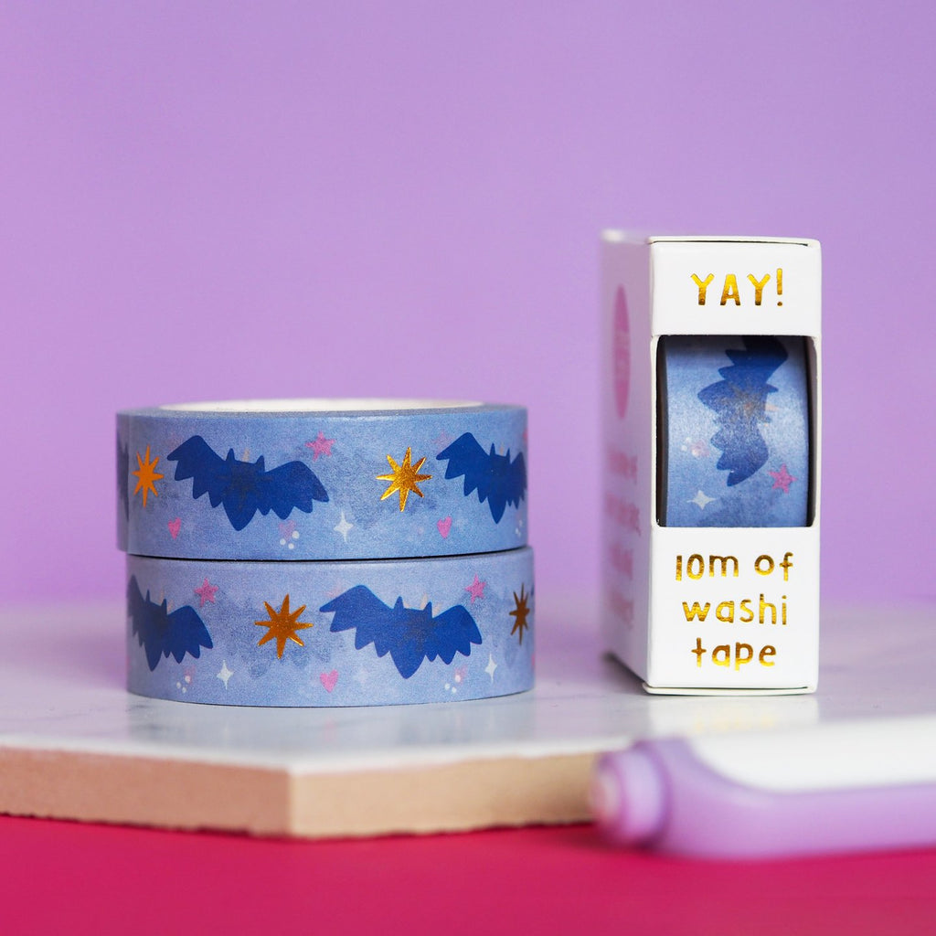 Decorative tape with blue background with images of blue bats, pink hearts, pink stars and gold foil stars.