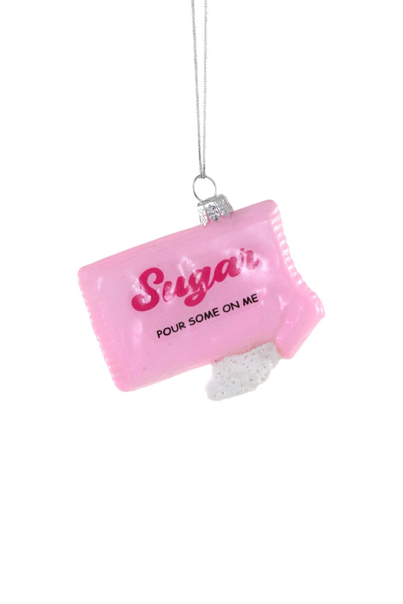 Image of a pink sugar packet with pink and black text says, "Sugar, pour some on me". 