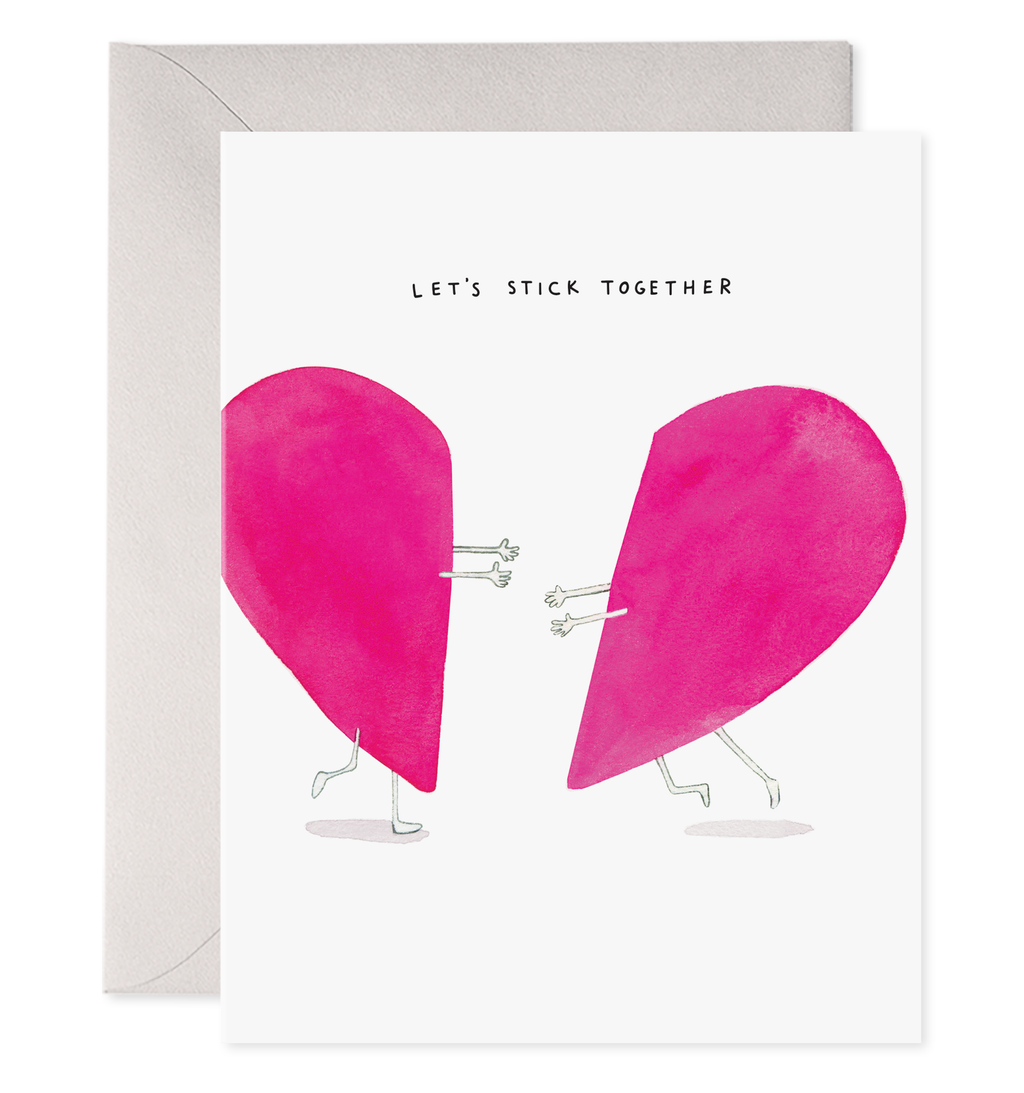 White card with black text saying, “Let’s Stick Together”. Image a pink heart split into two pieces with arms and legs running towards each other. A purple envelope is included.