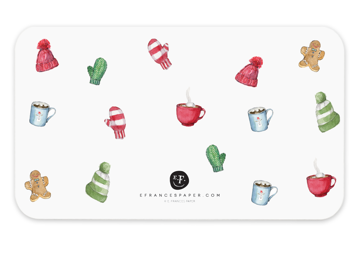 Image of reverse side of note card has white background with images of red knitted hats, green mittens, mugs of hot beverages, gingerbread cookies and red and white striped mittens.   