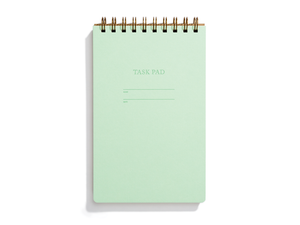 Image of mint cover with letter pressed text says, “Task pad”. “Name” and “Date” with lines for writing. Coiled binding on top.