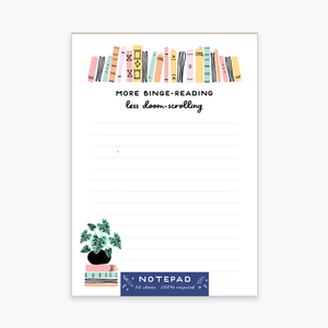 White background with image of a row of books at top of notepad with black text says, “More binge-reading less doom-scrolling”.  Image of stack of books with a plant on top of it.  Light grey lines for writing. 