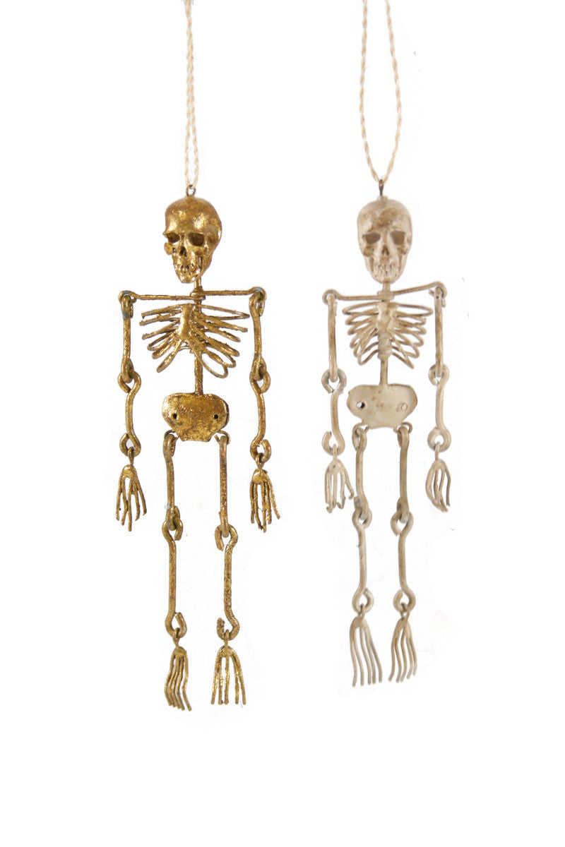 Images of two skeletons in gold and silver. 