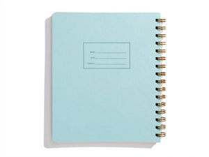 Image blue cover with letter pressed text says, “Name” and “Date” with lines for writing. Coiled binding on right side.