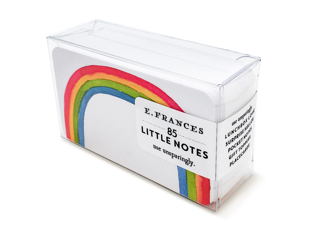 Image of a box of little notes. Image of note card has white background with an image of a rainbow in red, yellow, green, and blue. 