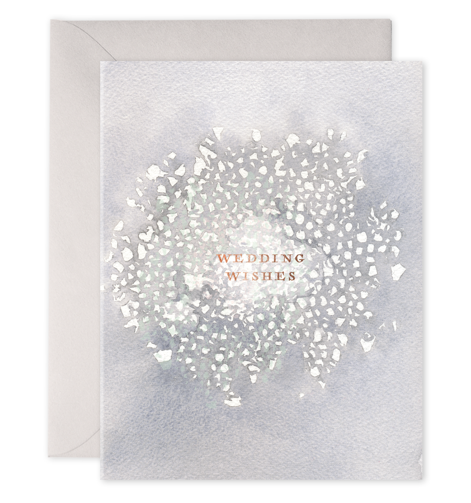 Gray card with gold text saying, “Wedding Wishes”. Image of a white floral pattern in middle of card. A gray envelope is included.