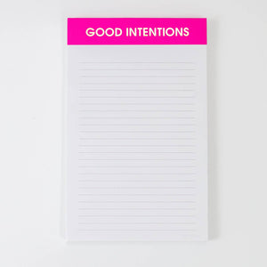 Image of a notepad with white lined paper a hot pink binding with gold foil text says, “Good Intentions”. 