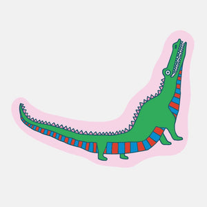 Pink background with image of green alligator with red and blue striped belly and pink scales along back. 