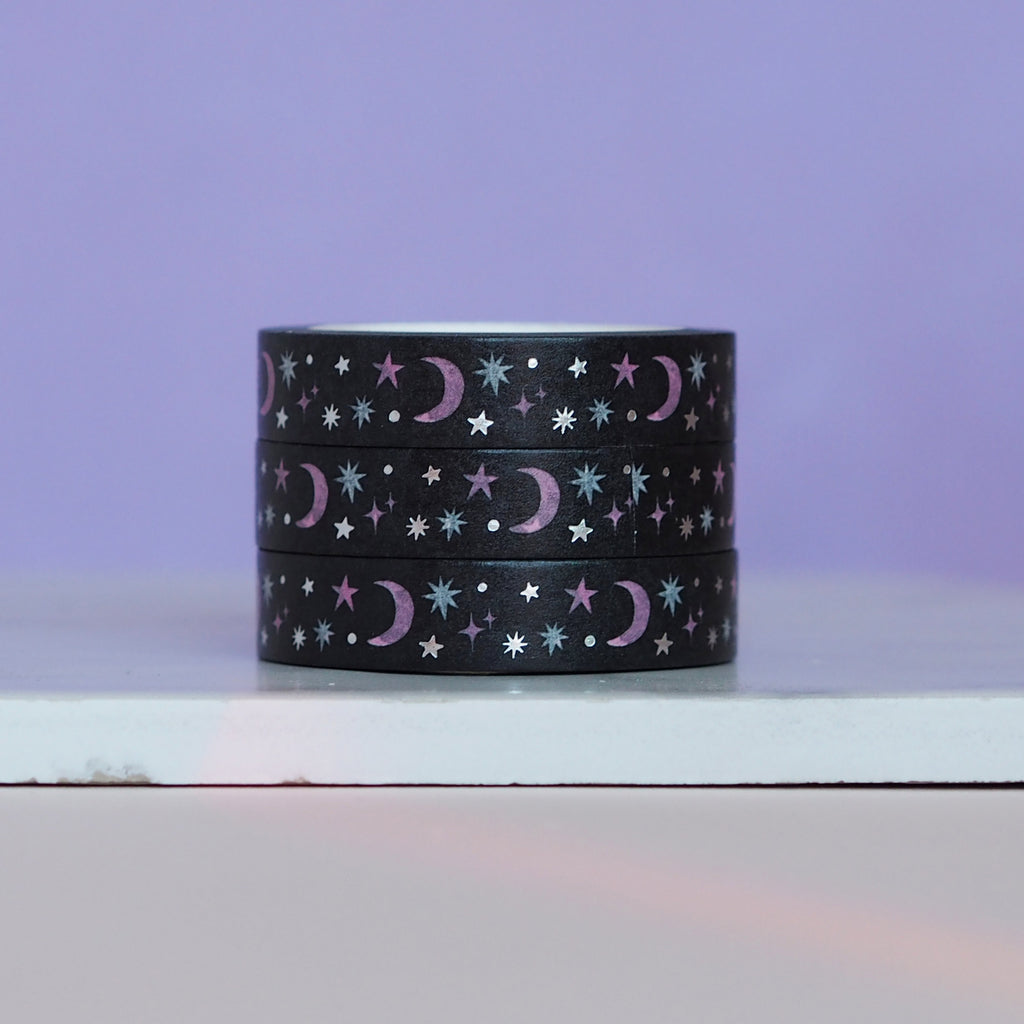 Decorative tape with black background with images of purple moon and blue, purple and silver metalic stars.