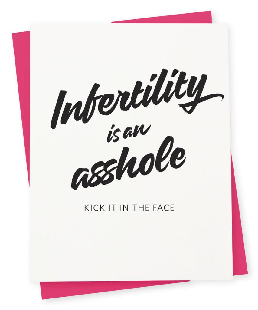 White card with black text saying, “Infertility is an Asshole Kick it in the Face”. A pink envelope is included.