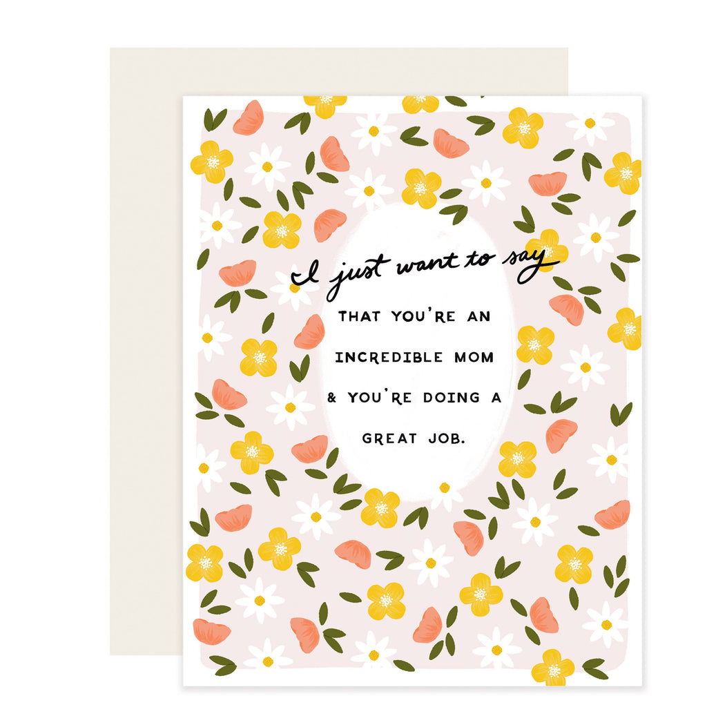 Pink card with black text saying, “I just want to say that you’re an incredible mom & you’re doing a great job”. Images of pink, yellow and white flowers with green petals scattered around card. A white envelope is included.