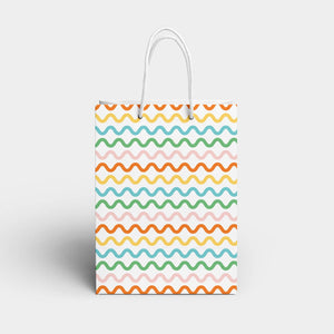 White background with orange, yellow, blue, green and pink squiggly lines repeated with white handle.   