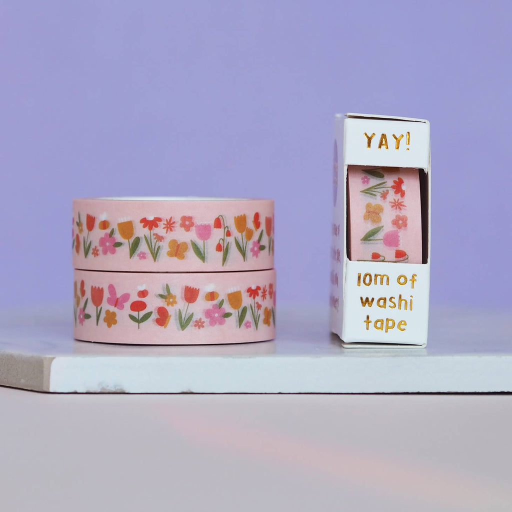 Pink background with images of  flowers and butterflies in red, orange, gold, pink  with green stems. 