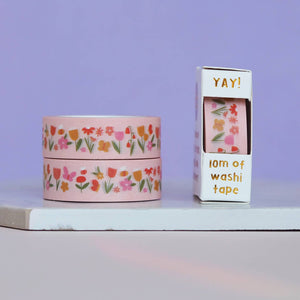 Pink background with images of  flowers and butterflies in red, orange, gold, pink  with green stems. 