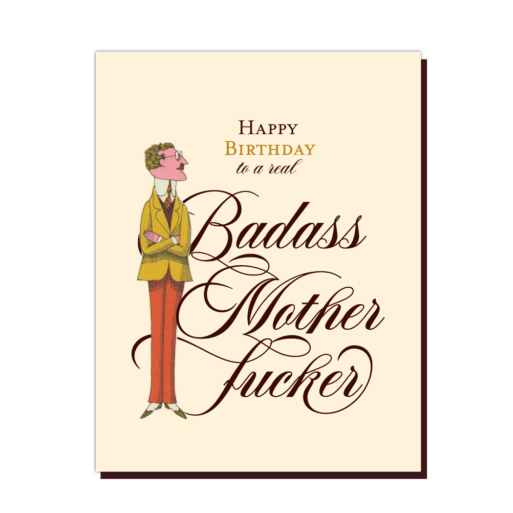 Tan card with brown script text saying, "Happy Birthday to a Real Badass Mother Fucker".  Image of a man standing tall in a yellow and orange suit.  A brown envelope is included.