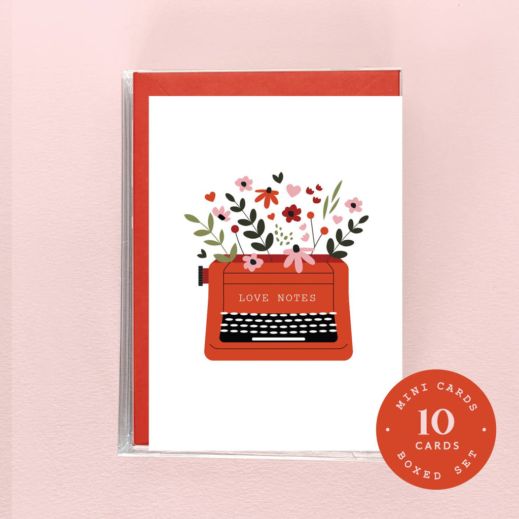 Image of red typewriter with red and pink flowers coming out of top on white background. Yellow text says, " Love note". Red envelopes included. 