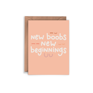 Peach card with white text saying, “New Boobs New Beginnings”. Images of sketches of pairs of breasts. A brown envelope is included.
