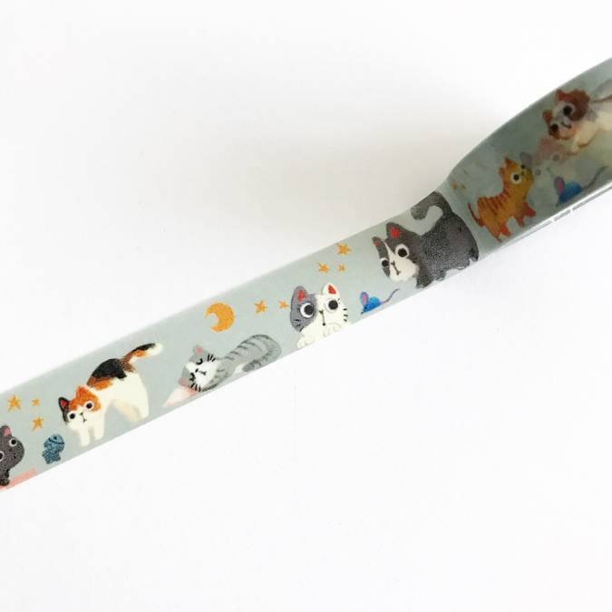 Gray tape with images of playful kittens and yellow stars and yellow moons in a repeating pattern.