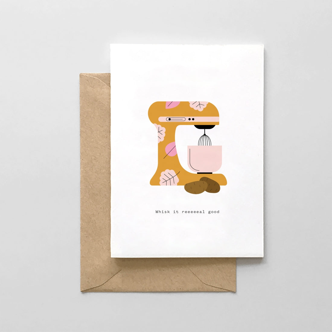 Ivory card with black text saying, “Whish it Reeeeeeeal Good”. Images of a mustard colored tabletop kitchen mixer with two brown potatoes next to it. A brown envelope is included.