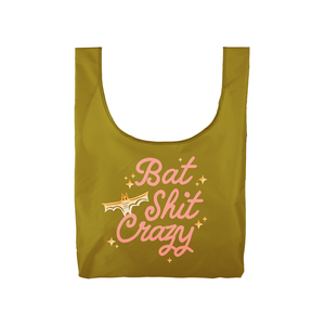 Image of gold bag with pink text says, “Bat shit crazy” with image of gold bat. 