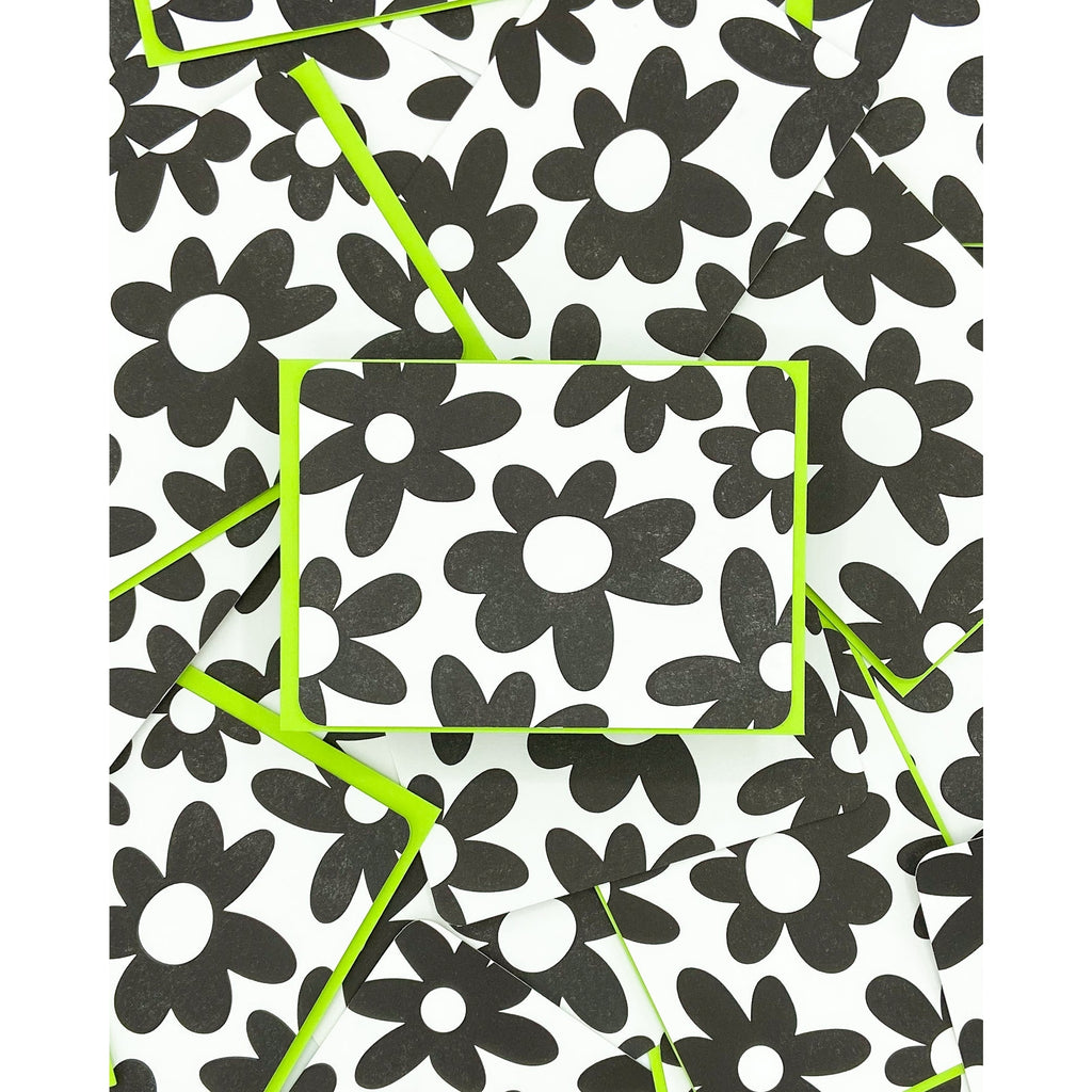 Black flowers with white centers on a white background with neon green envelopes.            