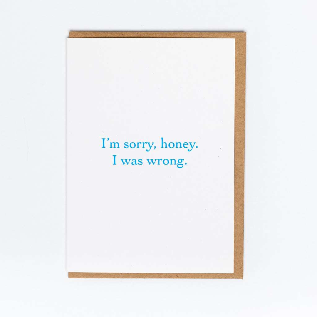 White card with teal blue text saying, "I'm Sorry, Honey. I Was Wrong".  A brown envelope is included.