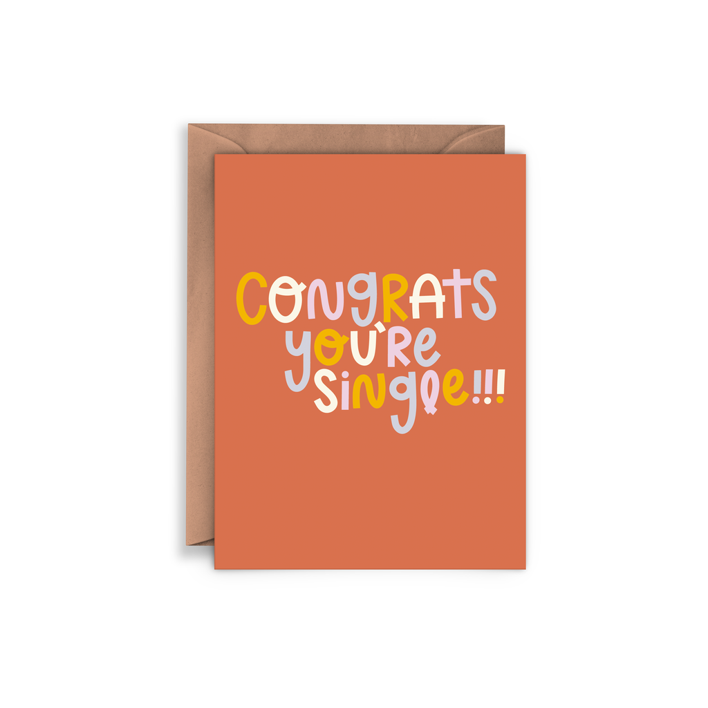 Orange card with rainbow text saying, “Congrats You’re Single!!” A brown envelope is included.