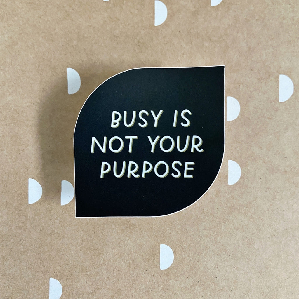 Black background with white text says, “Busy is not your purpose”.               