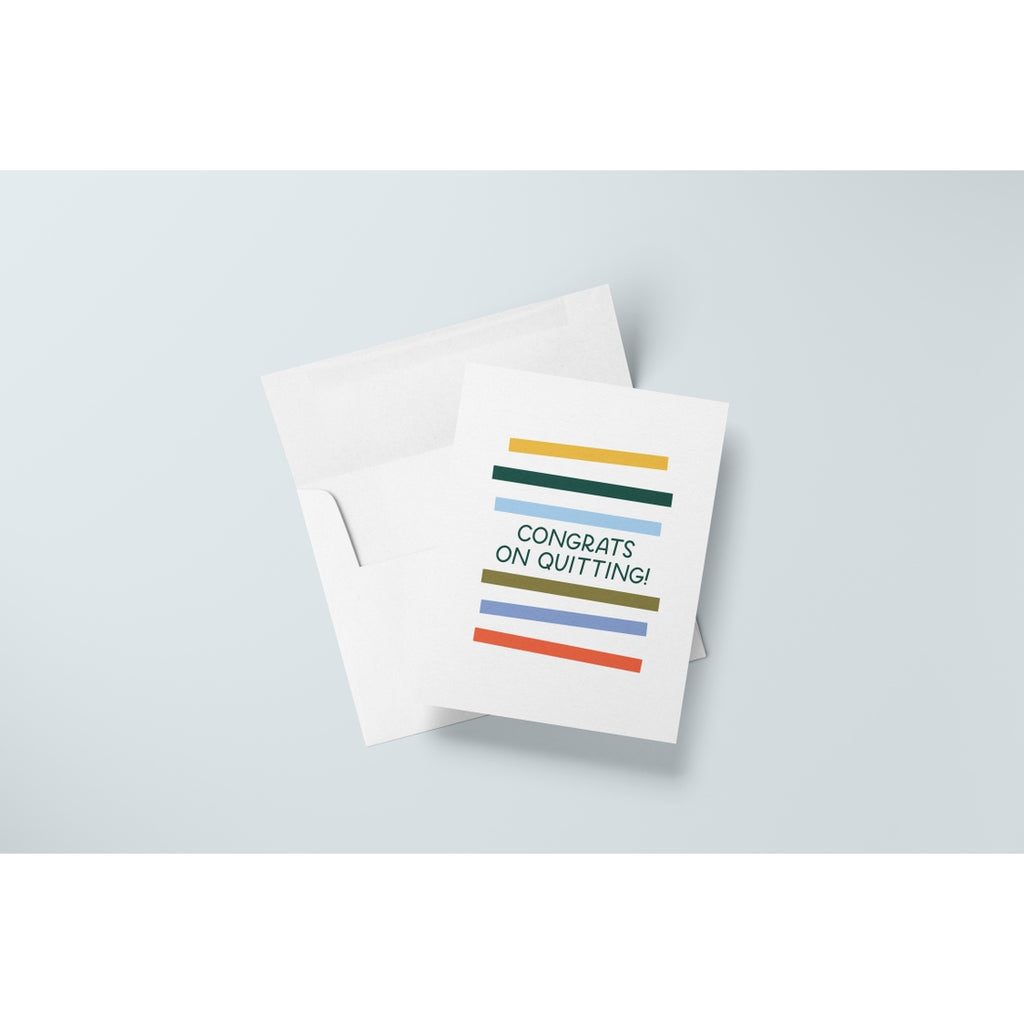 White card with green text saying, “Congrats on Quitting!” Images of rectangular colored stripes going down front of card. A white envelope is included. 