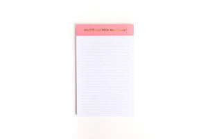 Image of a notepad with white lined paper and pink binding with gold foil text says, “What Shall I Fuck With Today”. 