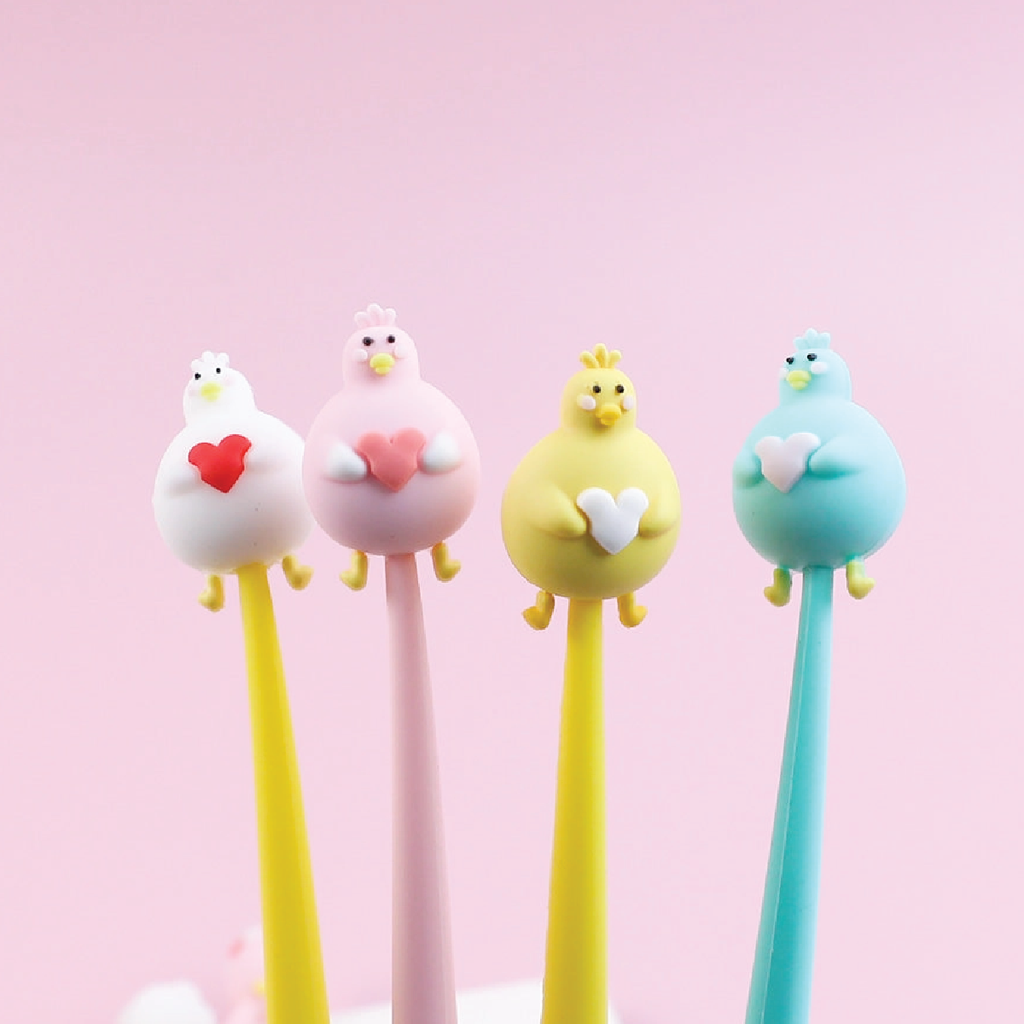 Image of four pens. A yellow barrel with a white duck with yellow feet holding a red heart, A pink barrel with a light pink duck with yellow feet holding a dark pink heart, a yellow barrel with a yellow duck with holding a white heart, and a mint duck with yellow feet holding a light pink heart.  